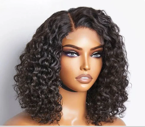 The model is showcasing our Ayanda Medi wig, which is a Deep Curly Peruvian Frontal wig, with a 13x4 ear to ear transparent swiss lace. The wig is Premium quality - 100% raw virgin human hair with cuticles intact and aligned. It is a glue-less wig with adjustable and detachable bands. It has a pre-plucked hairline and can be customised to a ready and go wig by adding bleached knots. Comes in length of 16” and forms part of our affordable range