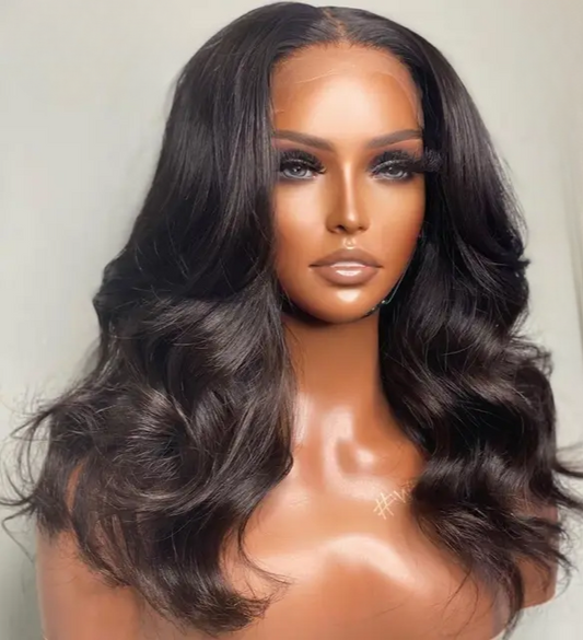 The model is showcasing our Lulama wig which is a long Body wave Brazilian Frontal wig, with a 13x4 or 13x6 ear to ear transparent swiss lace. The wig is Premium quality - 100% raw virgin human hair with cuticles intact and aligned. It is a glue-less wig with adjustable and detachable bands. It has a pre-plucked hairline and can be customised to a ready and go wig by adding bleached knots. Comes in lengths  22” and 24” and forms part of our affordable range