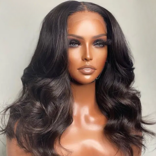 The model is showcasing our Lulama wig which is a long Body wave Brazilian Frontal wig, with a 13x4 or 13x6 ear to ear transparent swiss lace. The wig is Premium quality - 100% raw virgin human hair with cuticles intact and aligned. It is a glue-less wig with adjustable and detachable bands. It has a pre-plucked hairline and can be customised to a ready and go wig by adding bleached knots. Comes in lengths  22” and 24” and forms part of our affordable range